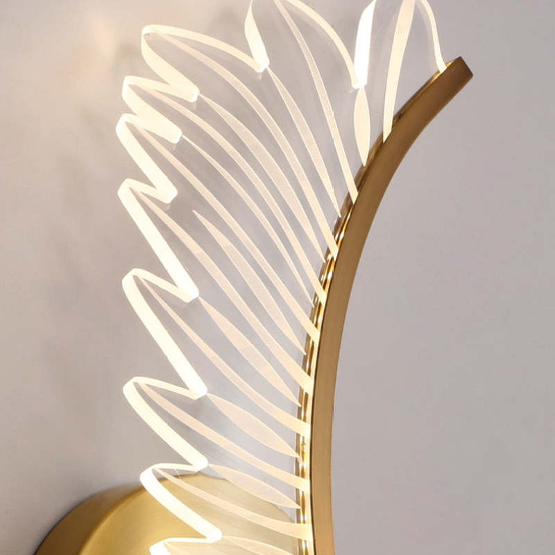 Close-up of Kristy clear feather-shaped shade and curved gold-tone metal