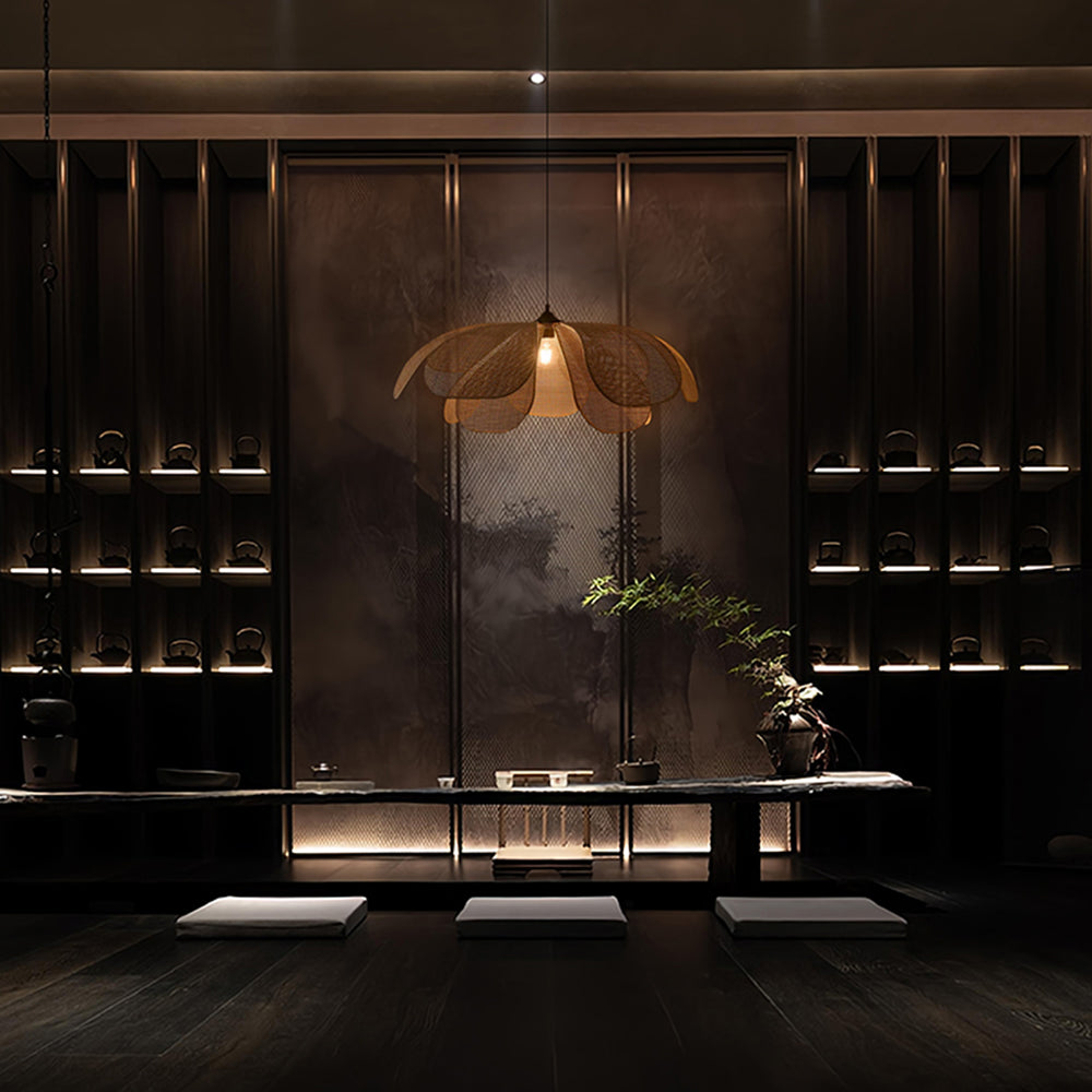 Ritta illuminated woven pendant above a low table in a dark wood interior