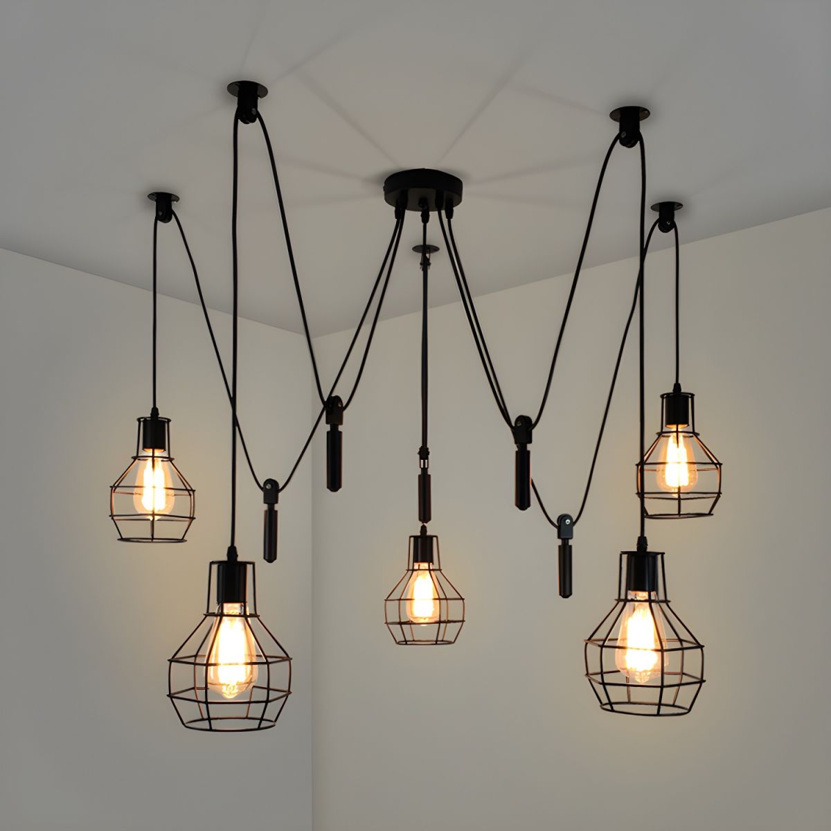 Alessio black cage lights glowing below multiple ceiling attachment points