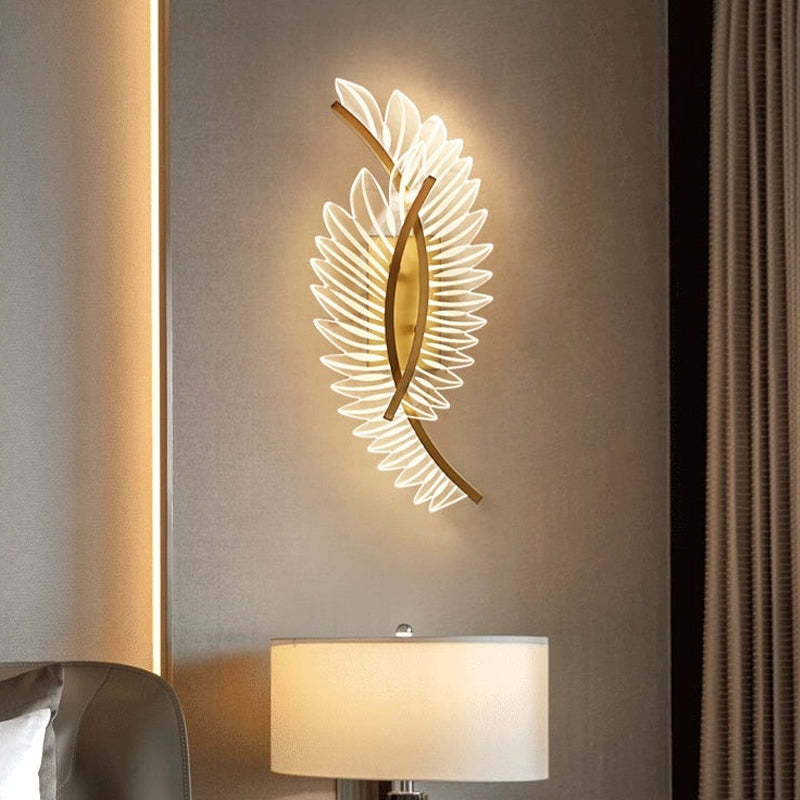Kristy Double feather-wing wall light casting a warm-looking glow above a table lamp
