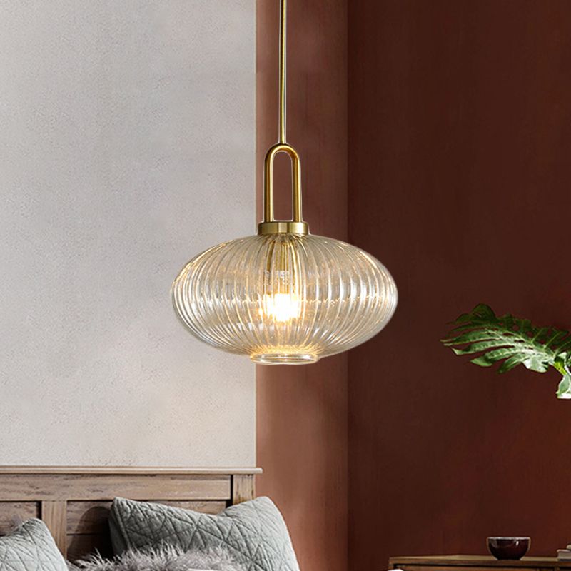 Wide low ribbed clear glass pendant in a living area