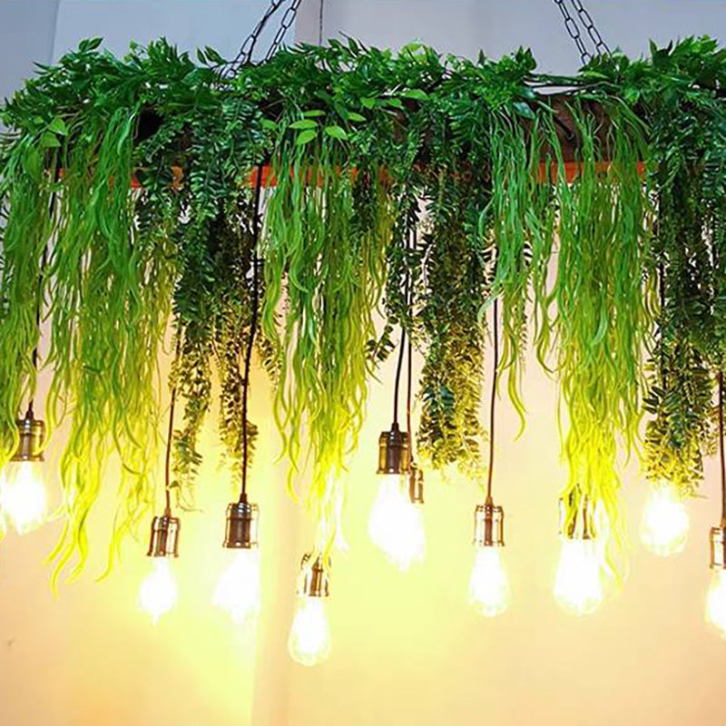 Close view of green foliage and exposed bulb shapes on staggered cords.