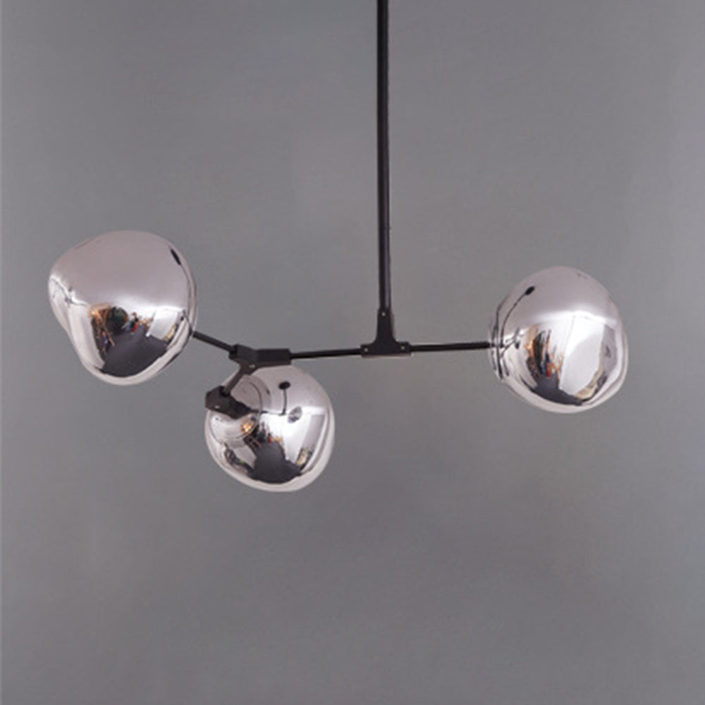 Three unlit reflective silver globe shades on dark branching arms and a central rod against a grey background