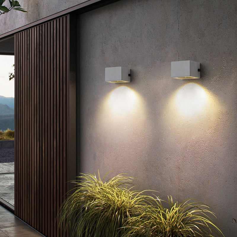 Two short cement blocks casting light down an exterior wall