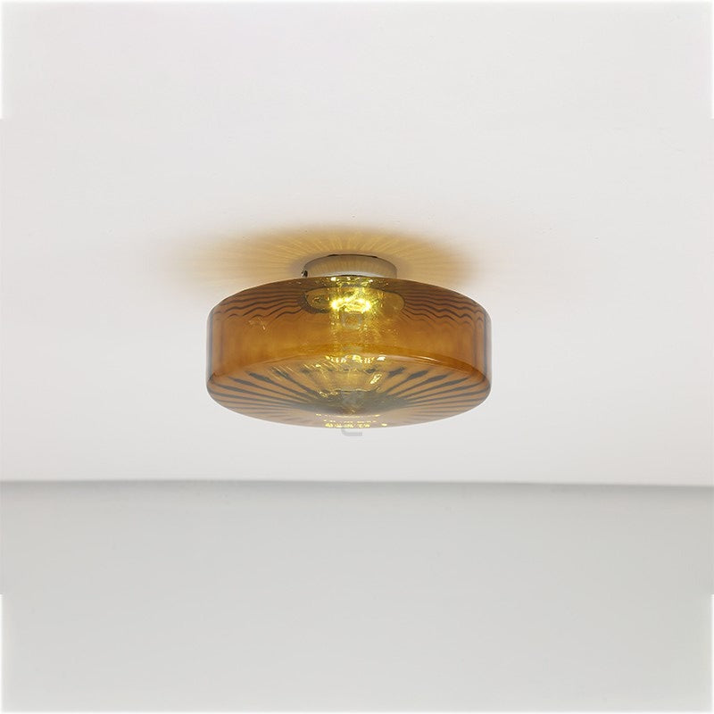 Illuminated Hailie brown round fixture against a white ceiling