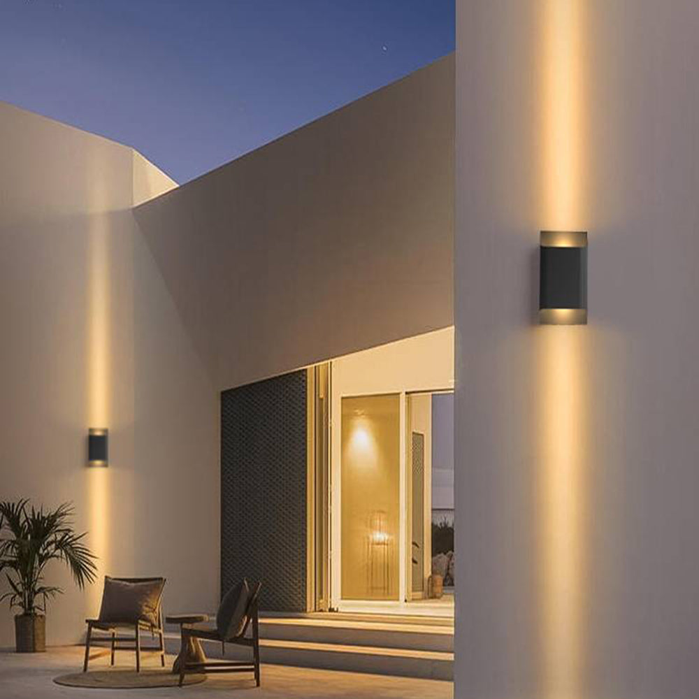 Two tall Orr up-down wall lights on an exterior wall at night