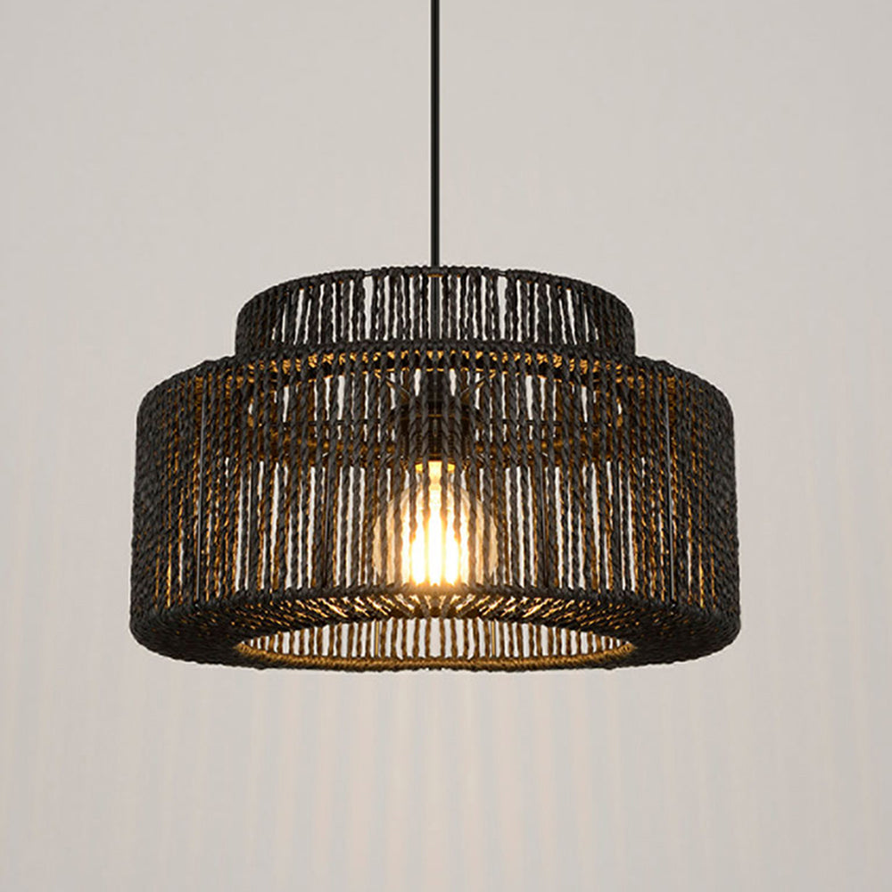Wide black woven drum pendant with its bulb illuminated