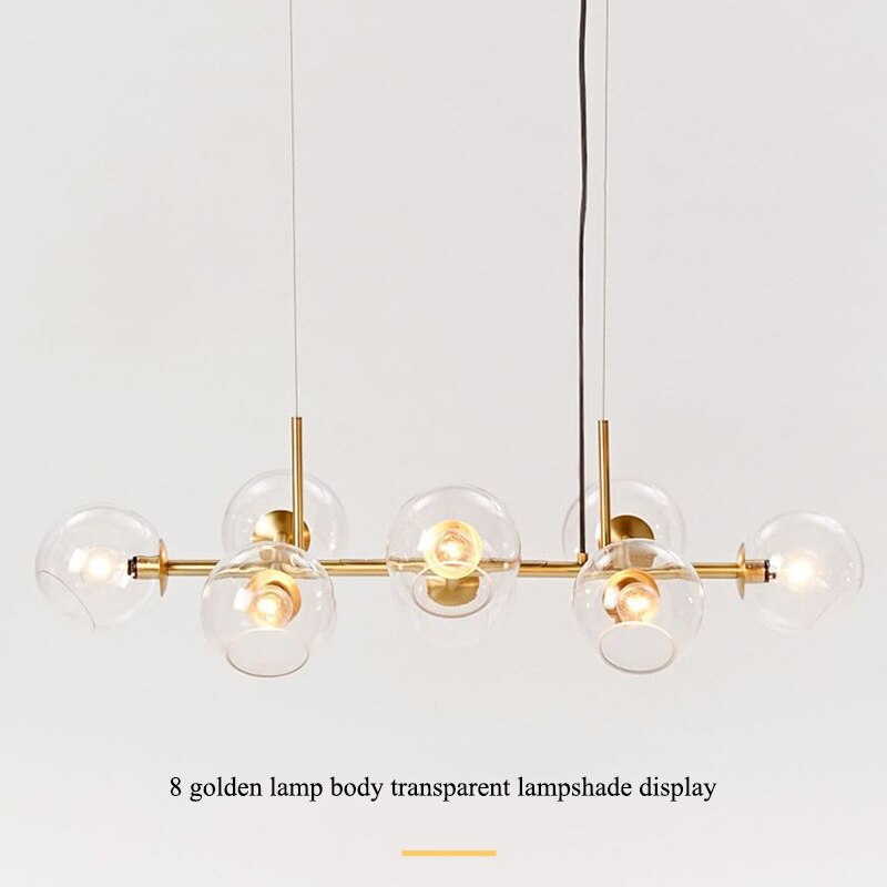 Gold-tone Valentina clear-globe pendant on a pale background, with an eight-head caption