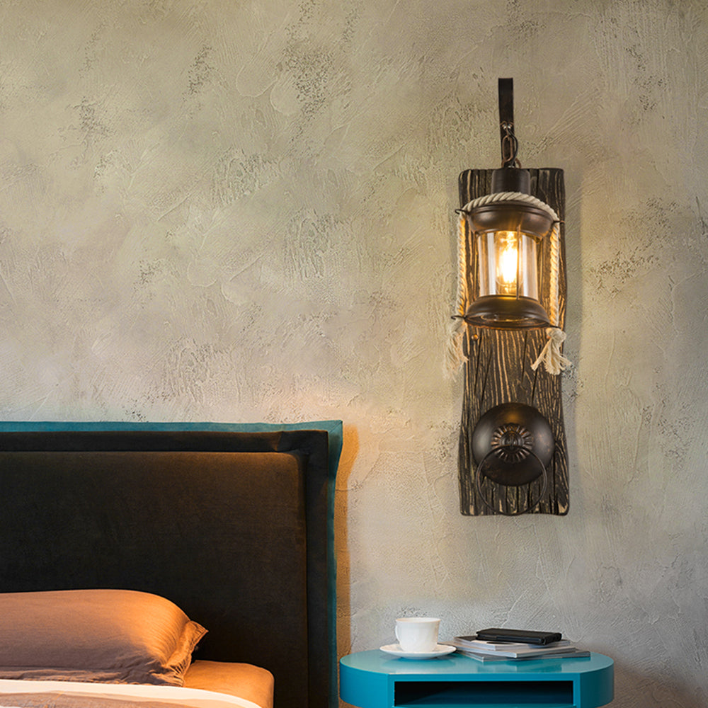 Alessio glowing lantern wall light beside a bed and teal bedside table