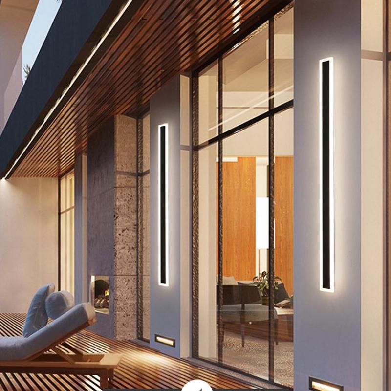 Vertical Edge wall lights along a terrace with glass doors and reclining chairs