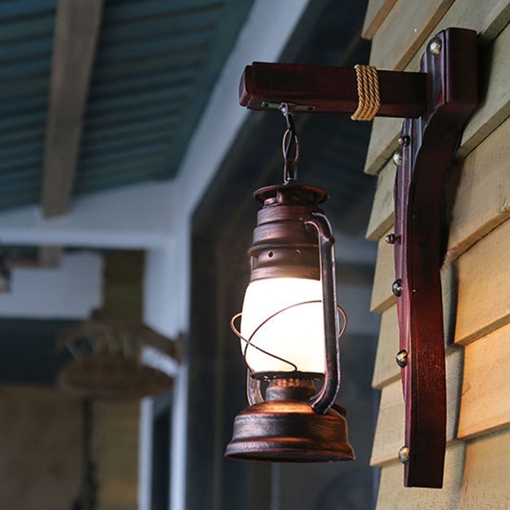 Close view of the glowing Austin lantern and curved wooden wall support.