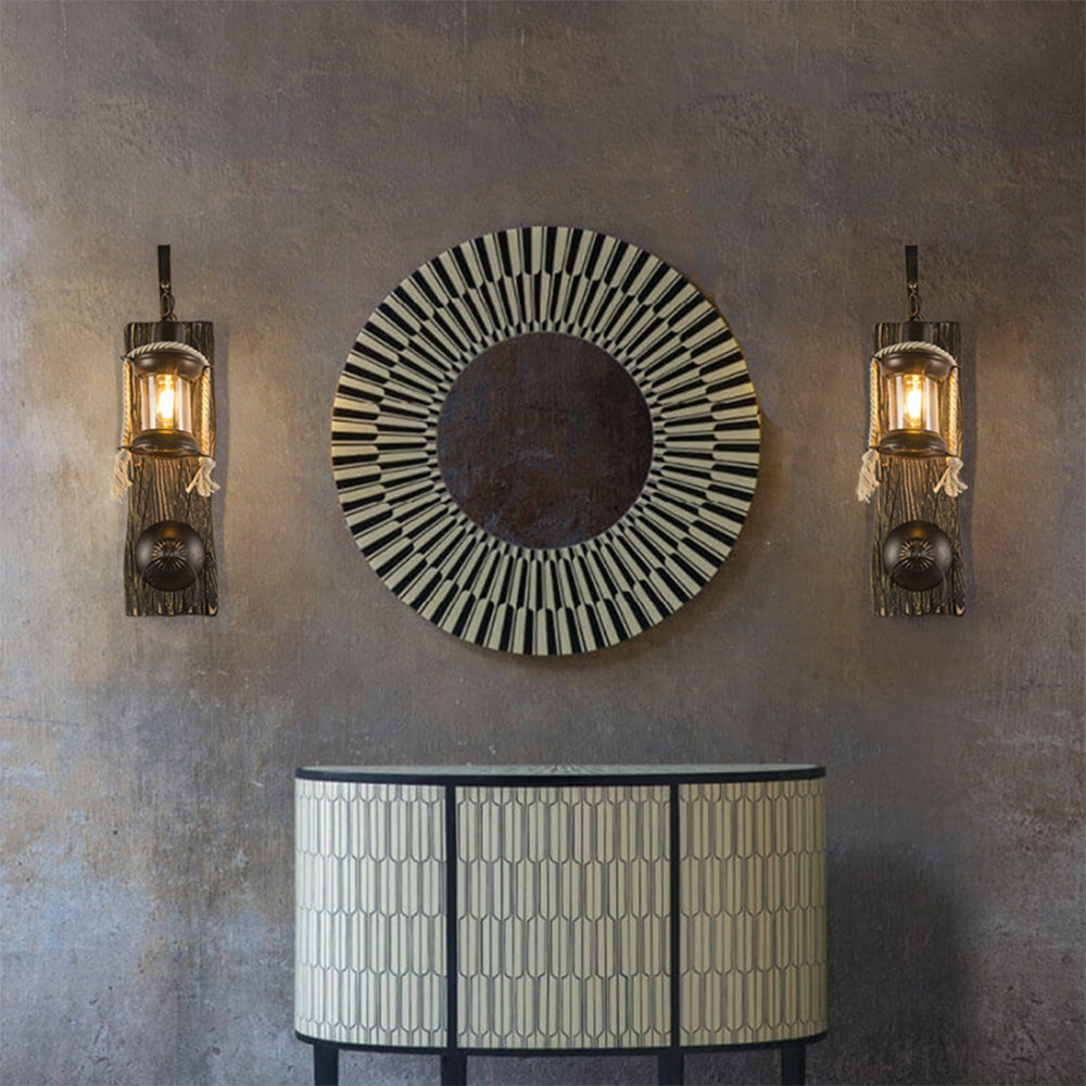 Two Alessio lantern wall lights flanking a round decorative mirror