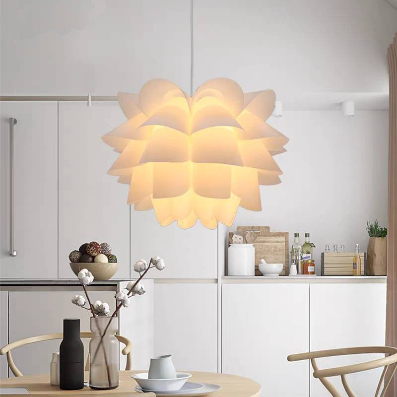 Cairns petal pendant above a round dining table in a pale kitchen.