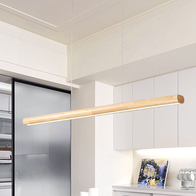 Wood-tone illuminated pendant bar in kitchen