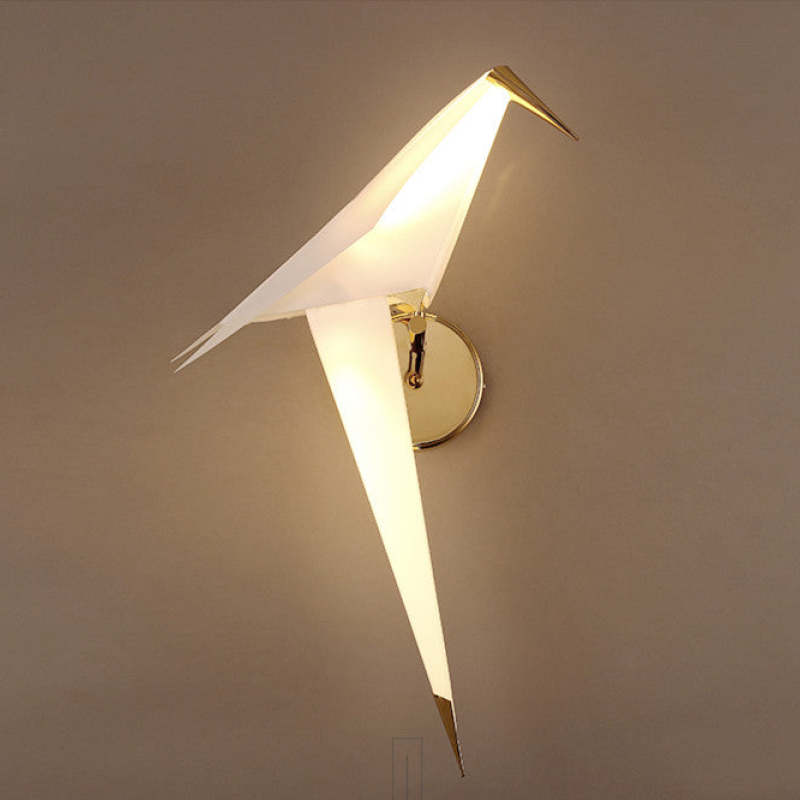 Close side view of one illuminated Clifford bird, with a gold-tone beak and pointed tail tip
