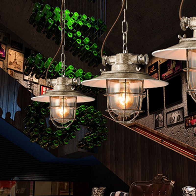 Two pale Alessio pendants above a restaurant table beside a staircase