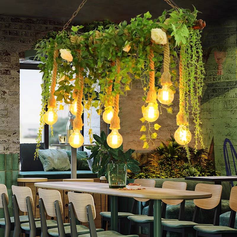 Nest foliage pendant above a restaurant table with pale green chairs