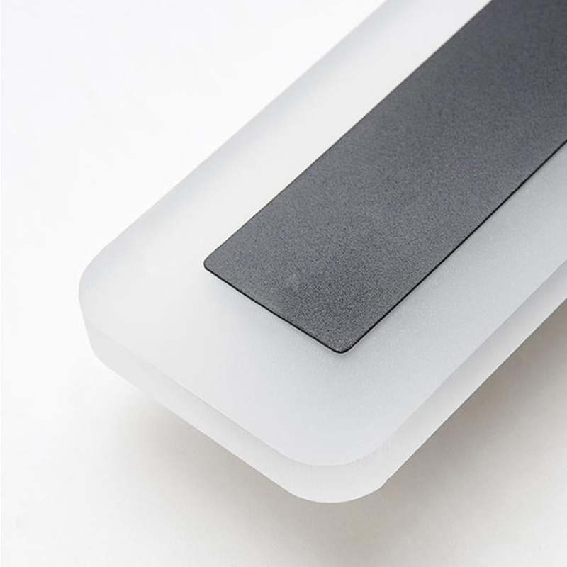 Close-up of the rounded corner where the dark face meets the translucent surround
