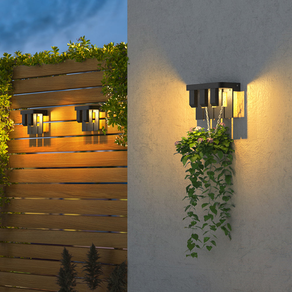 Orr two-element lights on a wooden screen and a three-element light on a grey wall above a hanging plant
