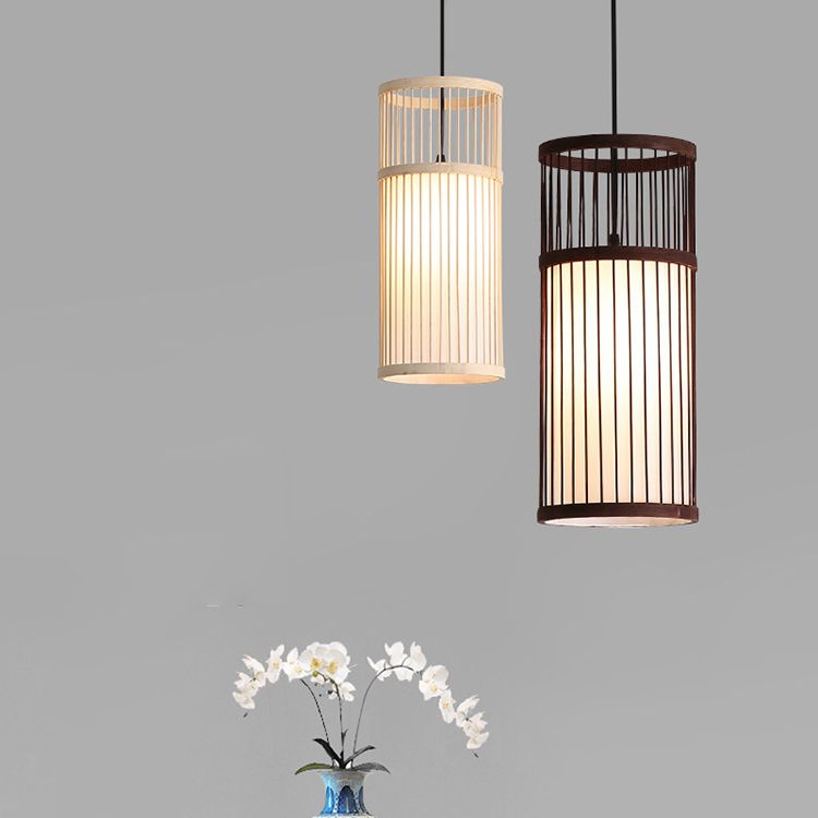 Wood and Coffee Ozawa cylinder pendants above a flower arrangement