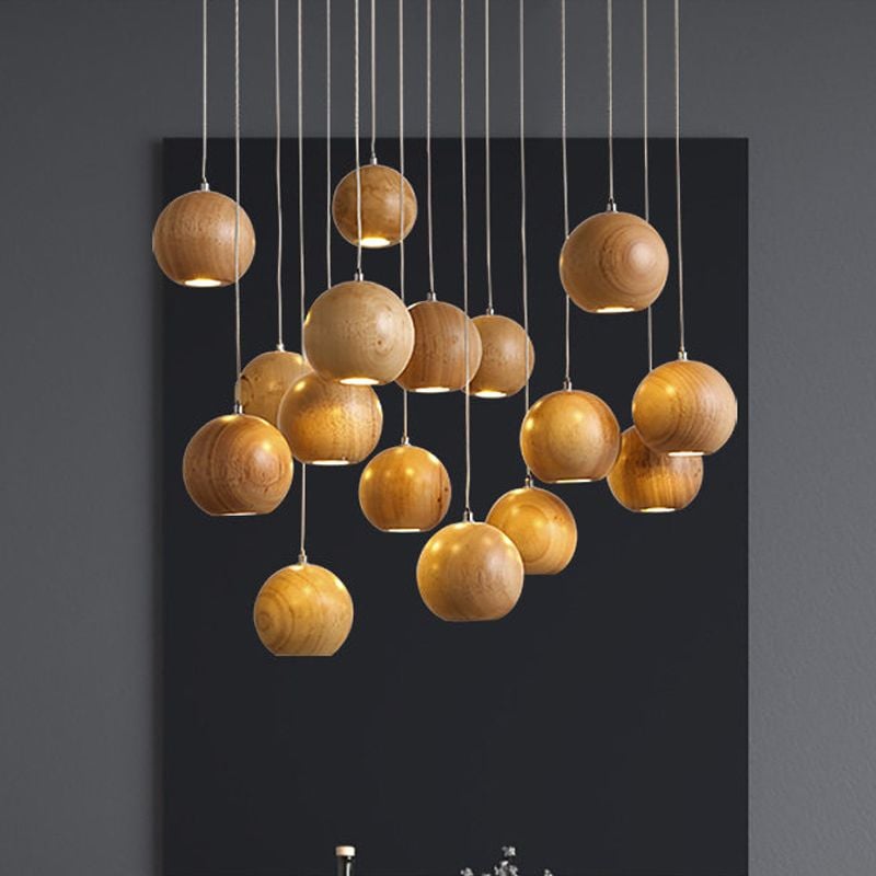 Wood-grain globe pendant cluster against dark wall