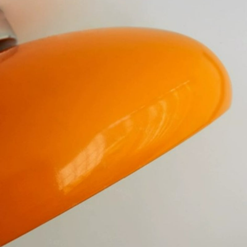 Close-up of the glossy orange curved exterior of the Morandi dome ceiling light