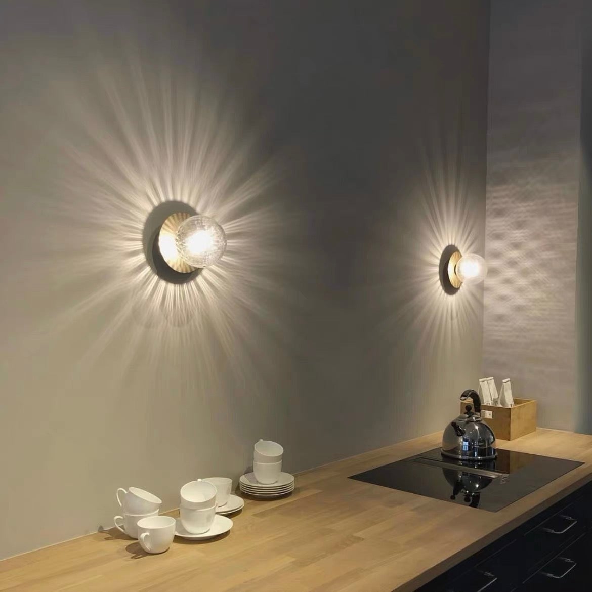 Two clear textured glass globe lights above a kitchen counter and hob