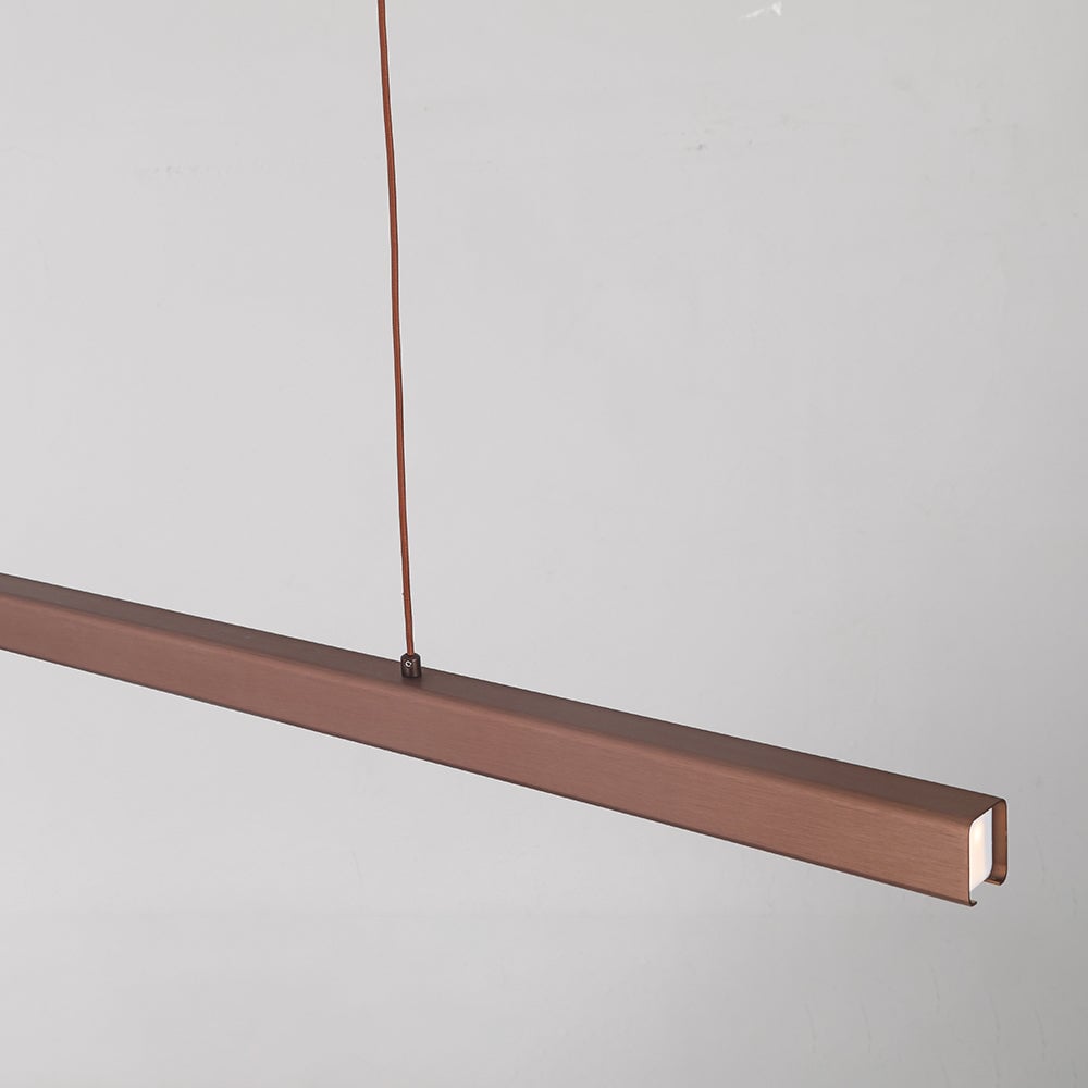Close-up of Brown Edge brushed housing, lit white end diffuser and top cord fixing