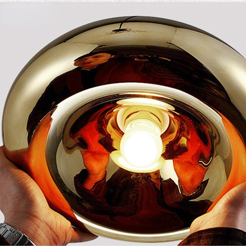 Underside of a gold glass pendant showing the bulb and lamp holder