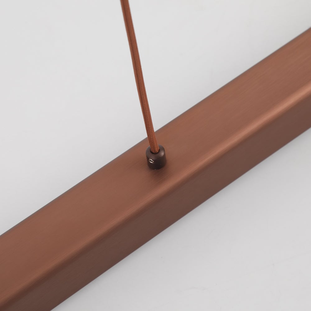 Close-up of Brown Edge cord entering a small dark fixing with side screw on top of the brushed bar