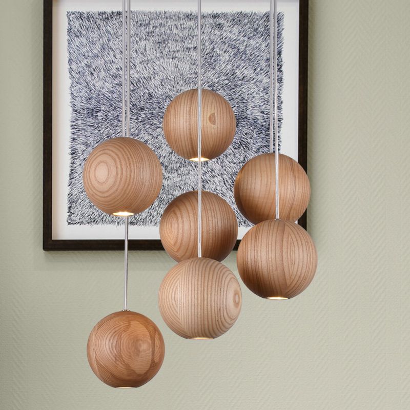 Seven suspended wooden globes beside framed wall art