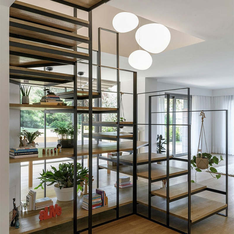 White pendant grouping beside open room shelving