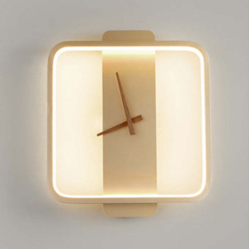 Close front view of lit gold-tone square Nielsen clock face and its rounded corners