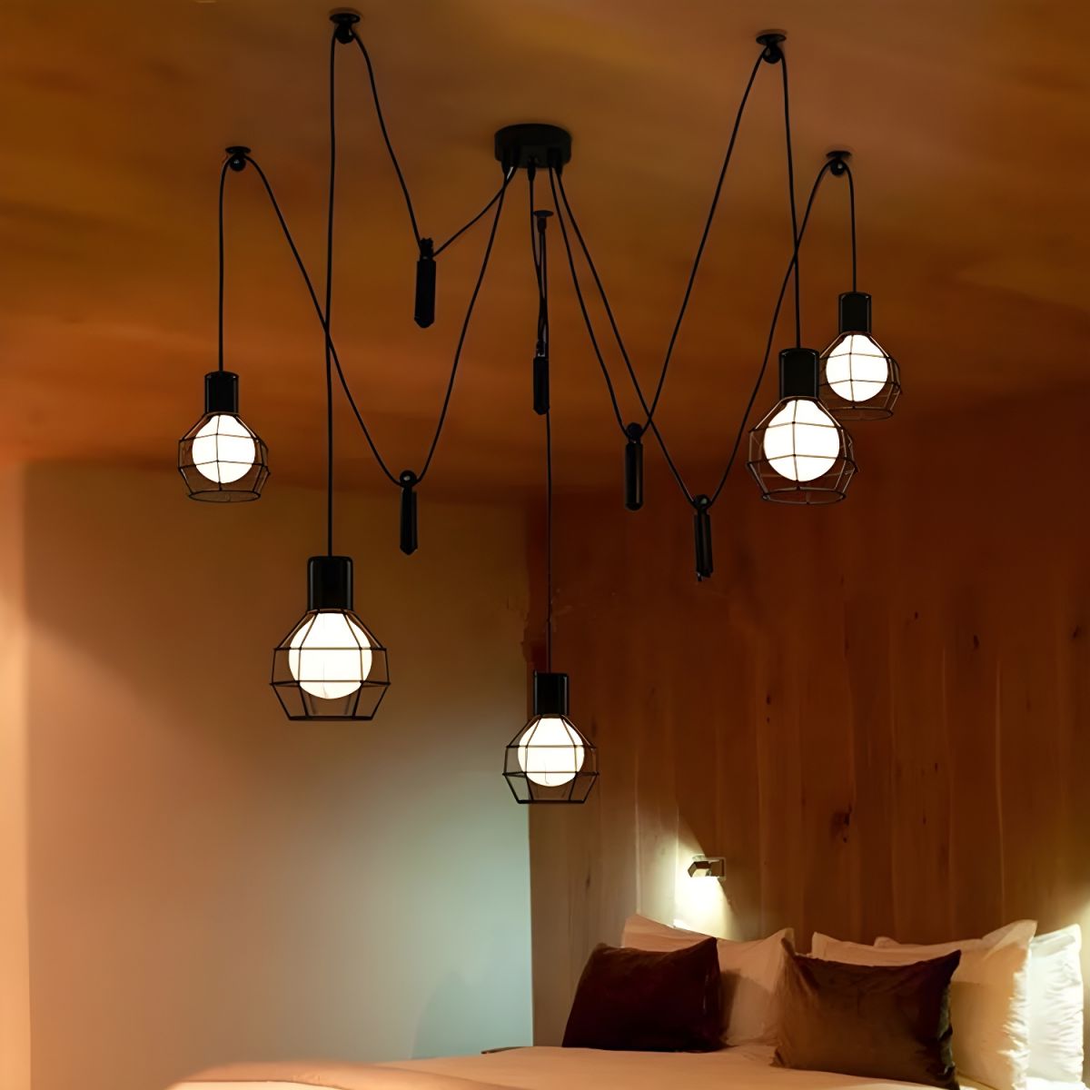 Alessio caged pendant with looping suspension above a bed