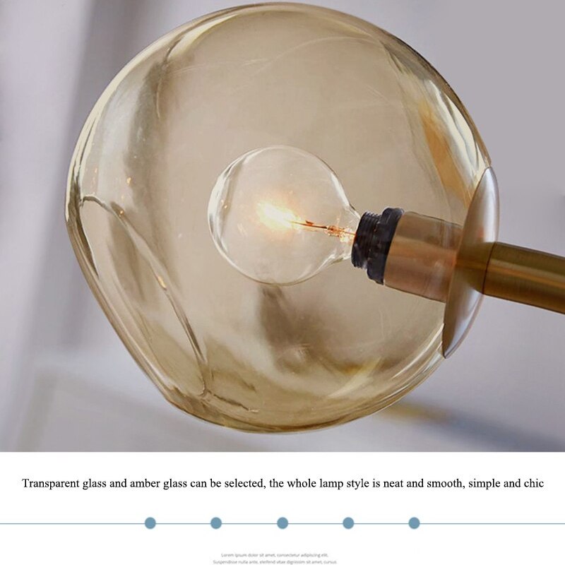 Close amber-looking globe and lit bulb on a gold-tone holder, with a caption mentioning transparent and amber glass