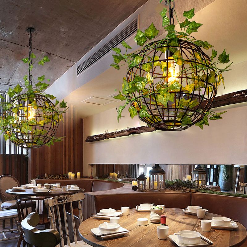 Nest vine-covered cage pendants above restaurant tables.