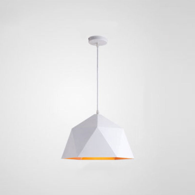 White faceted metal pendant with a warm metallic-looking interior, pale cord and white ceiling canopy