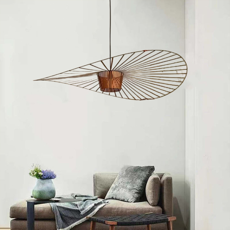 Brown wavy flower-like pendant with radial lines hanging above a chaise lounge and low tables