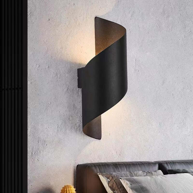Black wrap wall-light option on a textured wall above an upholstered bedhead