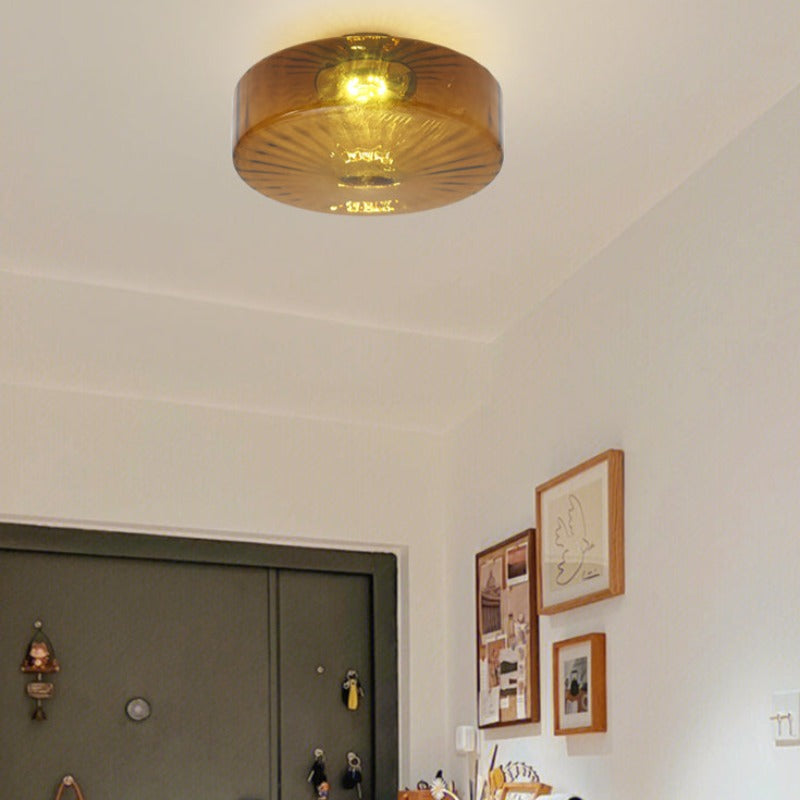Hailie brown flush-mount fixture near a doorway and framed pictures