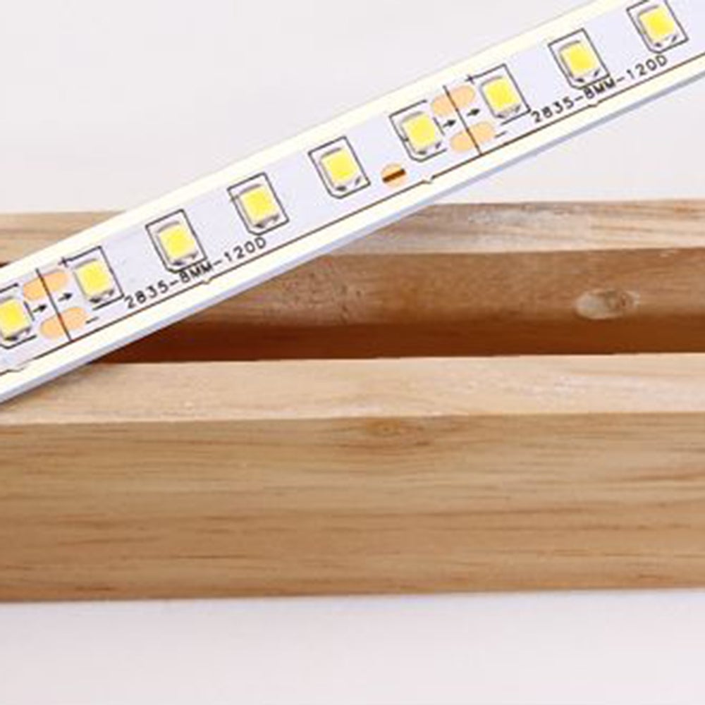 LED-strip detail above the wood-grain housing