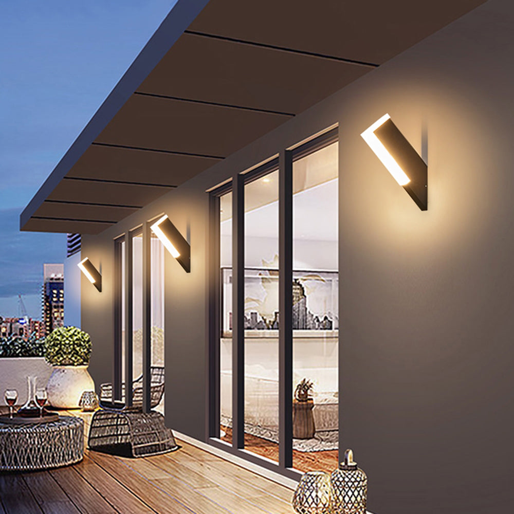 Separate angled Orr exterior wall lights beneath patio eaves
