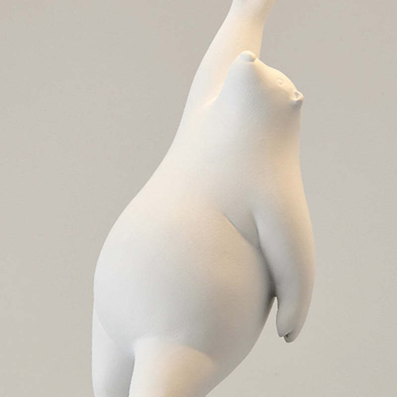 Close-up of a white bear ornament with one arm raised