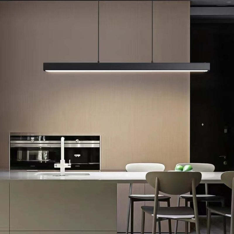 Black Edge light bar above kitchen island with sink and apples, wood cabinets, oven and grey chairs