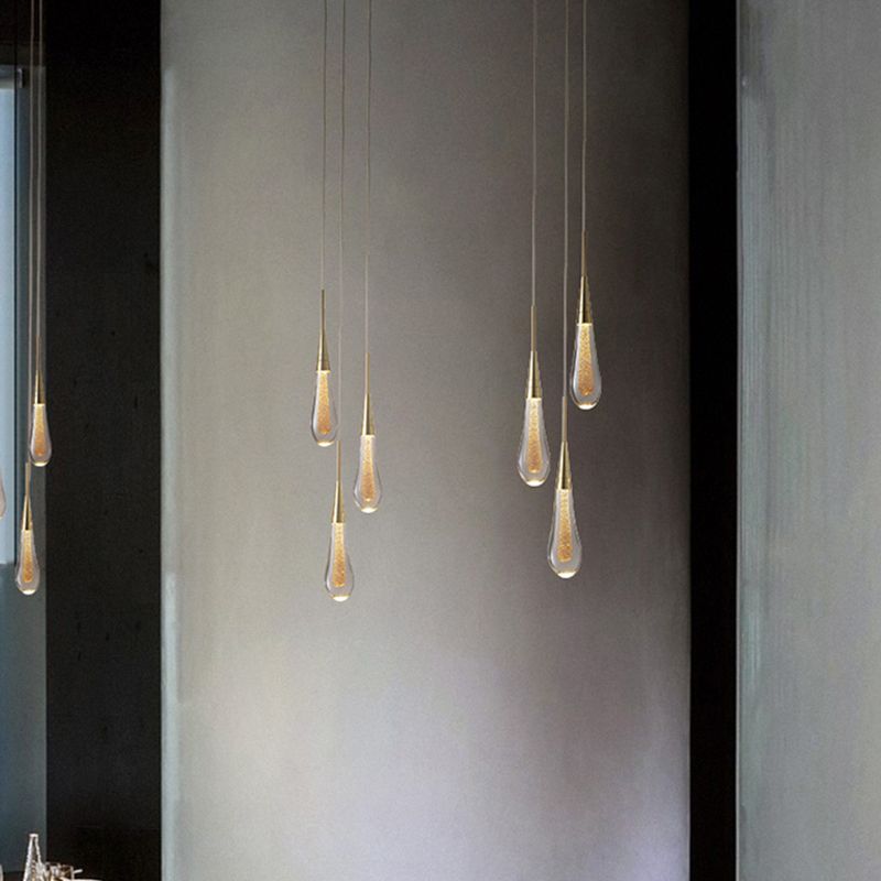 Two three-drop Hailie pendant groups at staggered heights beside a mirror and console