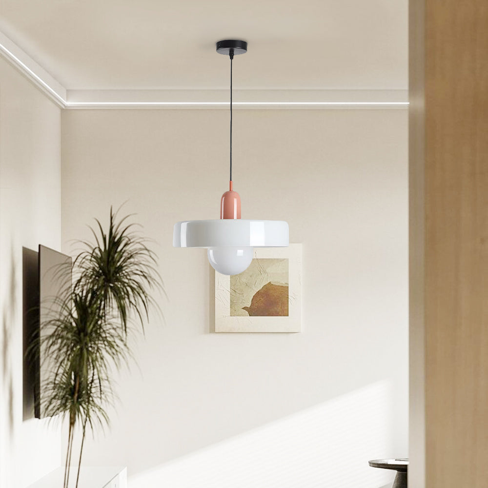 Pink-and-white Morandi pendant with black cord and canopy in a pale room with framed art and a tall plant