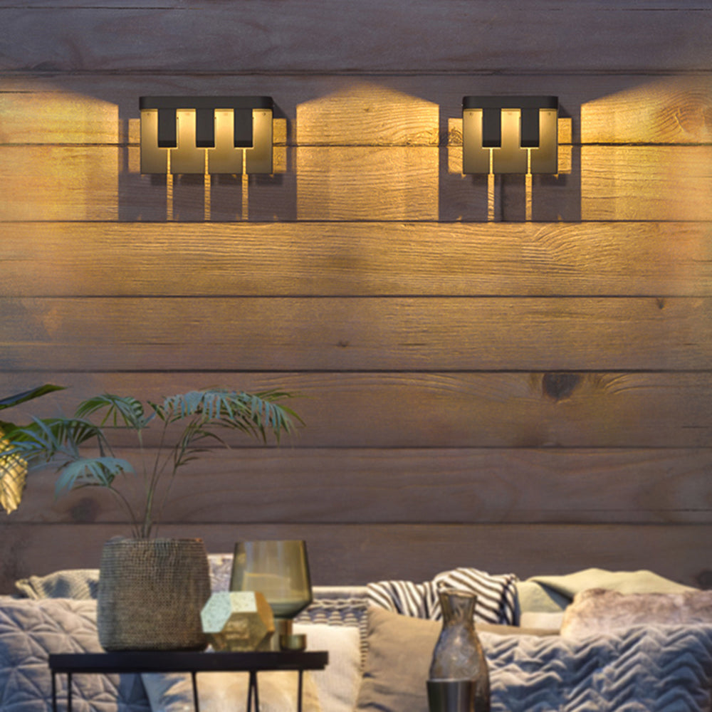 Orr three-element and two-element wall lights side by side on a wooden wall above a table and sofa