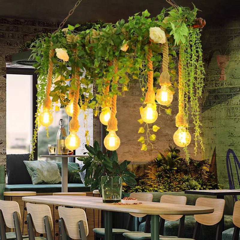 Nest foliage pendant over a dining table beside a cushioned bench