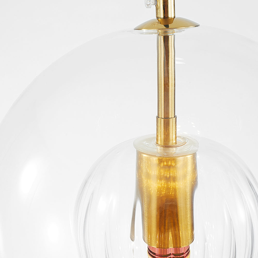 Close view of the gold-tone fitting inside a clear rounded globe