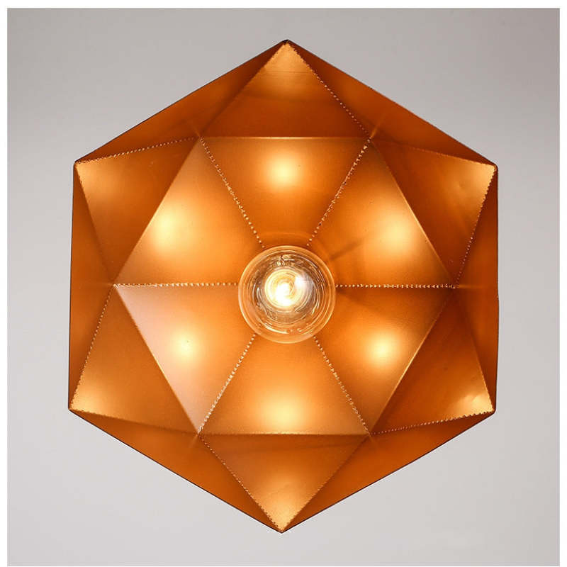Underside of a faceted shade showing a central illuminated bulb and triangular metallic-looking inner panels